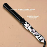 The Wavy West Black B1.25 rotating curling iron featuring a 32 MM barrel in a Black and Cowprint color, ideal for creating voluminous waves